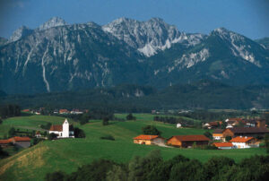 Hamlet community located in a valley beneath mountains.